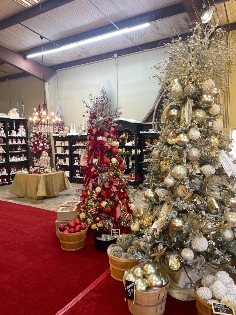 Red and gold themed Christmas trees with baskets of ornaments at Candy Cane Corner