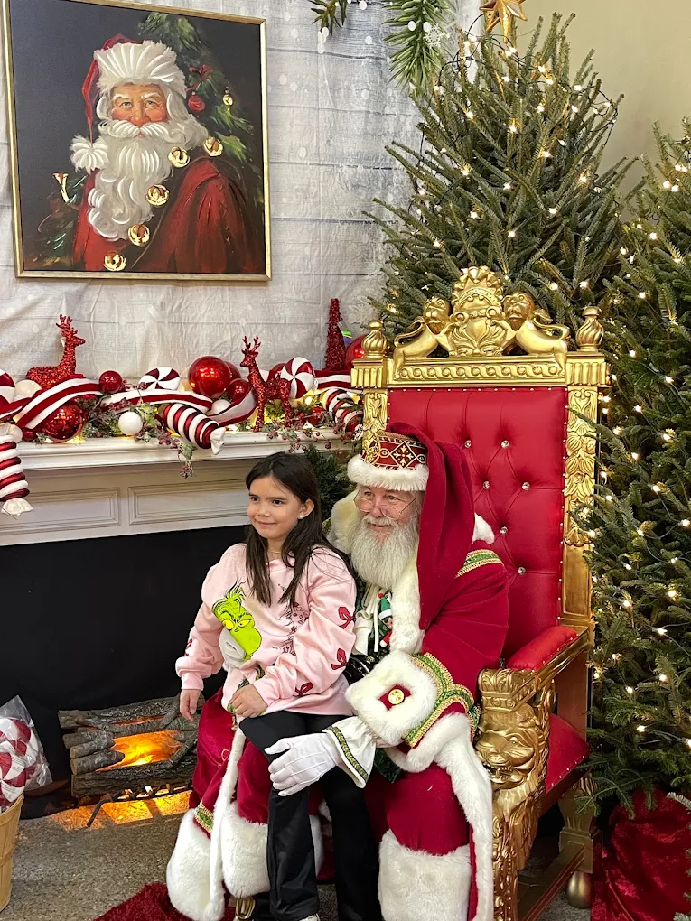 Santa greeting a young visitor at Candy Cane Corner