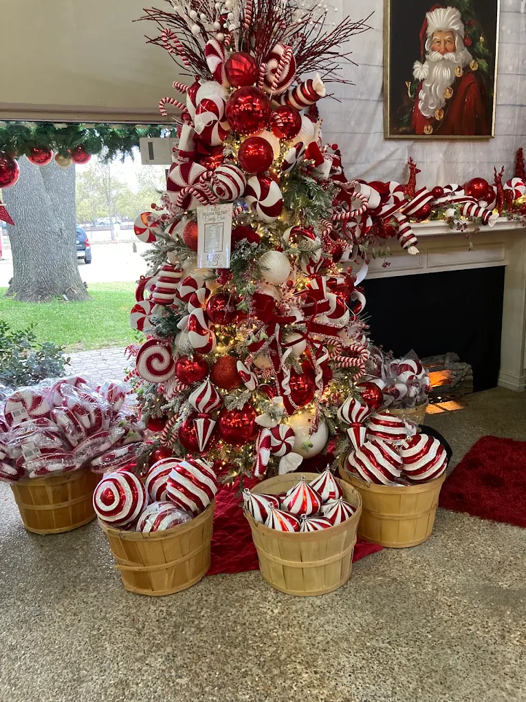 A themed Christmas tree with peppermint ornaments beside a fireplace and Santa portrait